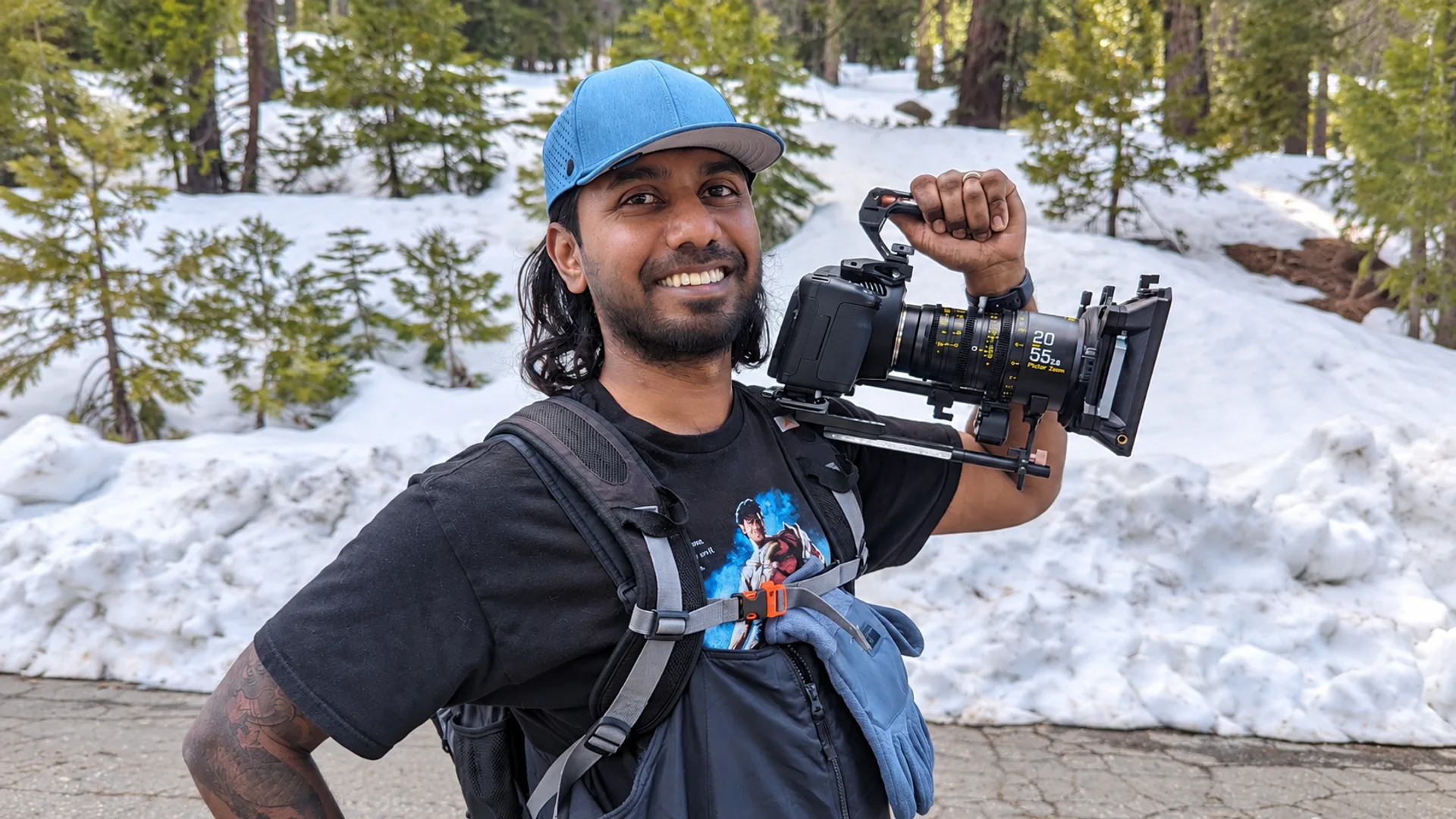 Neil holding his cinema camera in a snowy forest