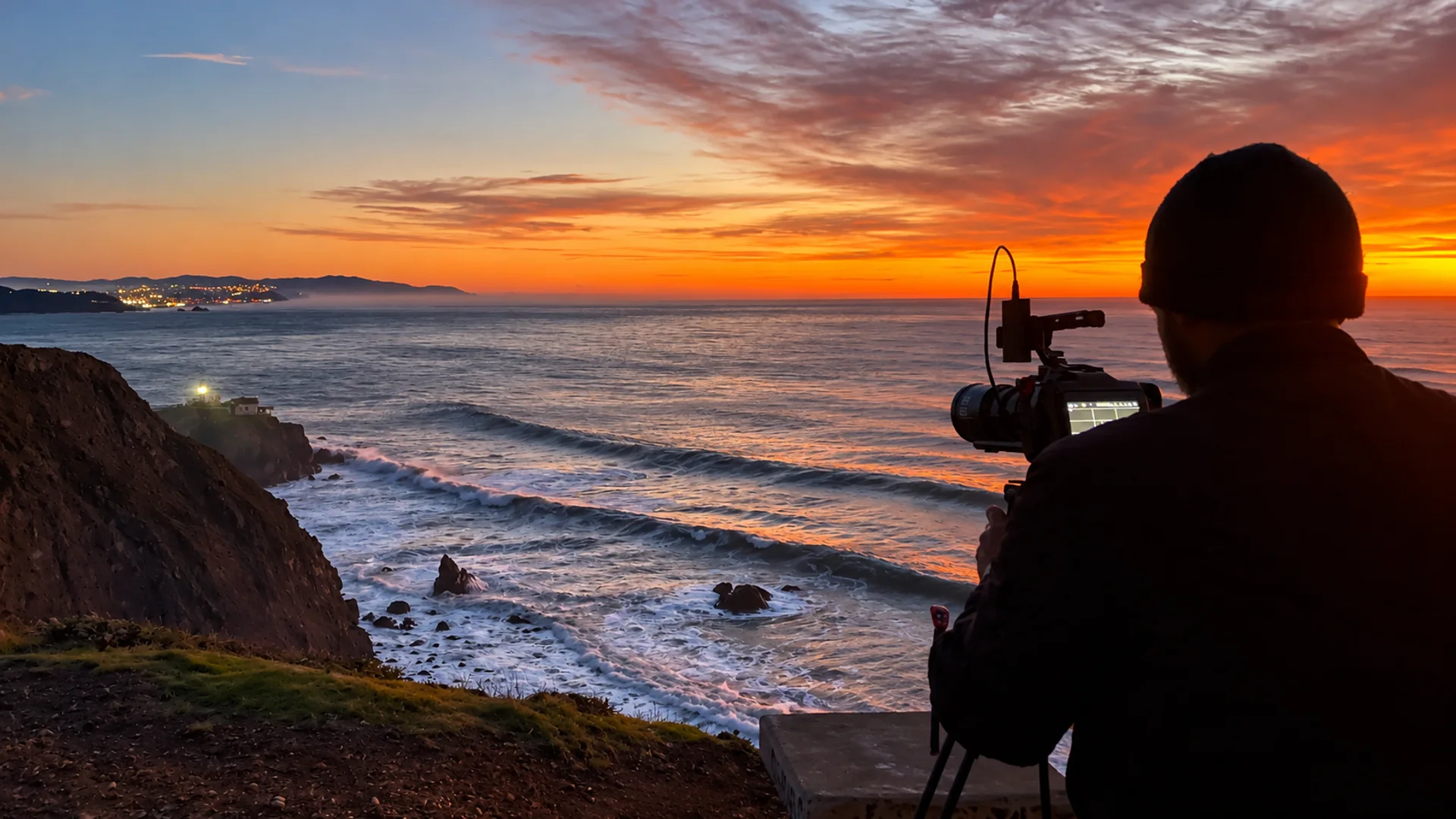 Neil filming an ocean sunset from the coast