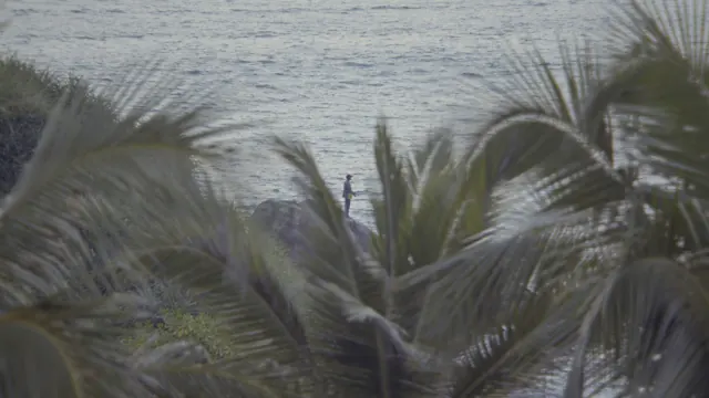 Man Fishing on Rocks at Hawa Beach, Kerala, India