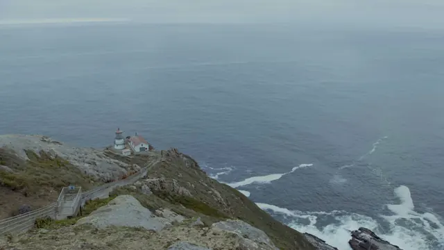 Point Reyes Lighthouse Perched on Foggy Cliff Above Pacific Ocean